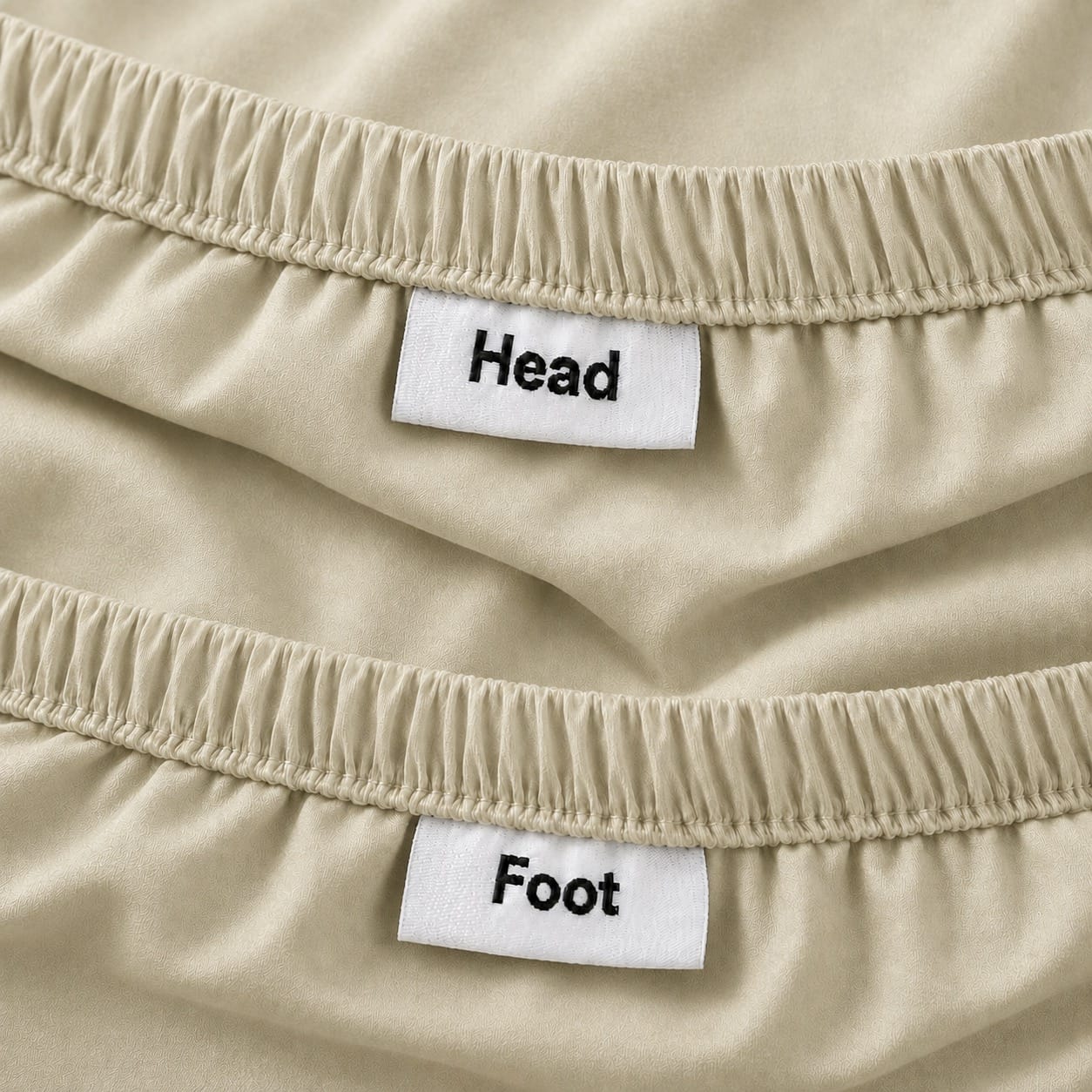 Beige fitted sheet with HEAD and FOOT orientation labels