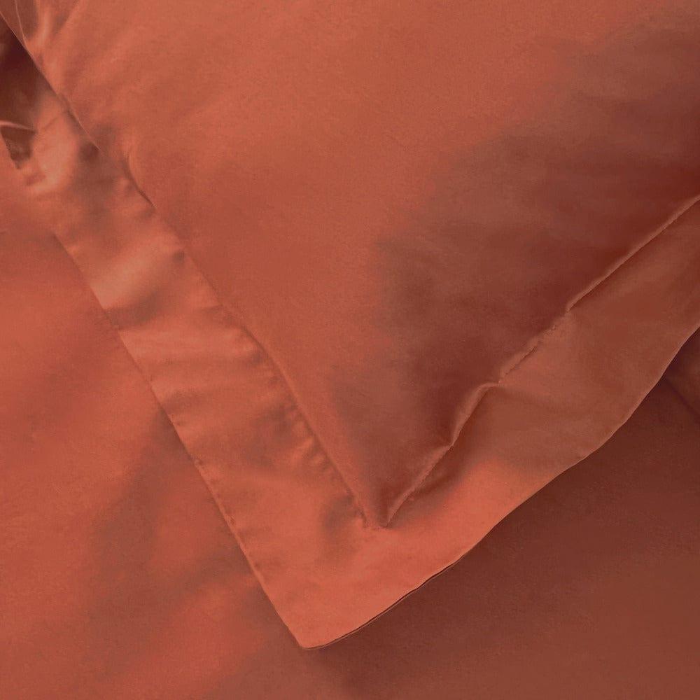 Partial front view of terracotta pillow sham